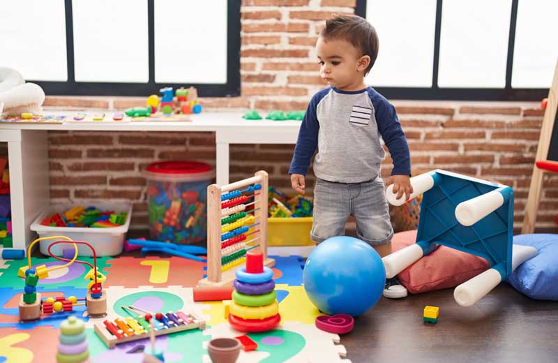 toddler standing with serious expression kindergarten