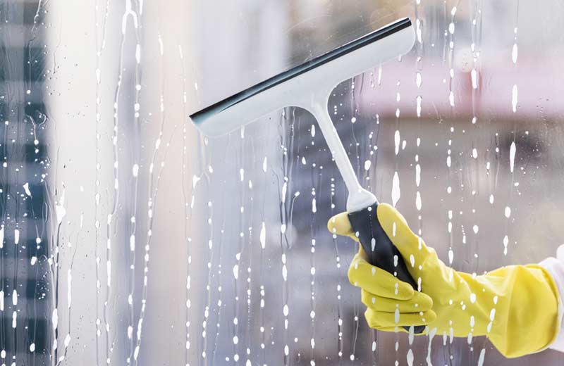 man cleaning window